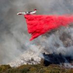 Firefighters race to contain LA wildfires as winds expected to pick up