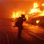 Thousands flee as winds drive wildfires into Los Angeles